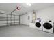 Laundry room with washer and dryer, with garage and water heater nearby at 131 Sonja Cir # 1, Davenport, FL 33897