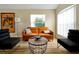 Inviting living room featuring a stylish leather sofa, a unique coffee table, and ample natural light at 131 Sonja Cir # 1, Davenport, FL 33897