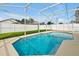 Screened-in swimming pool offers privacy and relaxation, surrounded by a well-maintained backyard with a white fence at 131 Sonja Cir # 1, Davenport, FL 33897