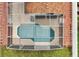Aerial view of pool under netting and small outside lounge area at 131 Sonja Cir # 1, Davenport, FL 33897