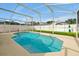 Sparkling swimming pool surrounded by a screened enclosure at 131 Sonja Cir # 1, Davenport, FL 33897