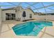 Inviting swimming pool in a screened enclosure with seating and a covered patio at 131 Sonja Cir # 1, Davenport, FL 33897
