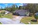 Aerial view of a single-Gathering home with a driveway, garage, and well-manicured lawn at 16 Cedar Dr, Davenport, FL 33837