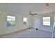 Bedroom with three windows providing natural light and neutral carpeting, creating a serene atmosphere at 16 Cedar Dr, Davenport, FL 33837