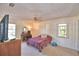Neutral bedroom featuring a ceiling fan, carpet, and large window that provides plenty of natural light at 16 Cedar Dr, Davenport, FL 33837