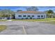 Exterior view of community center with landscaping and ample parking at 16 Cedar Dr, Davenport, FL 33837