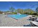 Community in-ground pool with lounge chairs, picnic tables, and a small bath house in a fenced area at 16 Cedar Dr, Davenport, FL 33837