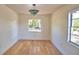 Cozy dining room with hardwood floors, a decorative light fixture, and natural light at 16 Cedar Dr, Davenport, FL 33837