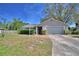 Charming single-story home with a well-maintained lawn and a two-car garage at 16 Cedar Dr, Davenport, FL 33837