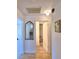 Hallway with view of the bathroom featuring a mirror, white cabinets and drawers, and decorative lighting at 16 Cedar Dr, Davenport, FL 33837