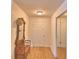 Hallway featuring hardwood floors, a bench with a decorative mirror and closet with mirrored doors at 16 Cedar Dr, Davenport, FL 33837