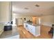 Open kitchen with hardwood floors, center island, and white cabinetry leading to a dining and living space at 16 Cedar Dr, Davenport, FL 33837