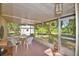 Relaxing screened porch with ceiling fan and views of the landscaped backyard at 16 Cedar Dr, Davenport, FL 33837
