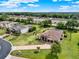Aerial view of a luxury home boasting a three-car garage, screened pool, and manicured lawn at 16548 Caravaggio Loop, Montverde, FL 34756
