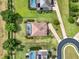 Overhead shot of a home with a beautiful tile roof, screened pool, mature trees, and paver driveway at 16548 Caravaggio Loop, Montverde, FL 34756