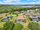 Gorgeous aerial view of luxurious homes with screened pools, solar panels, and a serene lake backdrop at 16548 Caravaggio Loop, Montverde, FL 34756