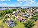 Scenic aerial view showcasing a residential neighborhood with beautiful homes and a tranquil lake at 16548 Caravaggio Loop, Montverde, FL 34756