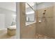 Shower with tan tile, a soaking tub, and a view into the bathroom at 16548 Caravaggio Loop, Montverde, FL 34756