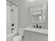 Bathroom with tile shower and floors, toilet, mirror, and granite vanity with contemporary black faucet at 16548 Caravaggio Loop, Montverde, FL 34756