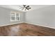 Bedroom showcasing laminate wood flooring, ceiling fan, and a bright window view at 16548 Caravaggio Loop, Montverde, FL 34756