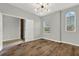 Cozy bedroom with wood floors, neutral walls, arched window, and modern ceiling fan at 16548 Caravaggio Loop, Montverde, FL 34756