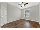 Bedroom with hardwood floors, neutral walls, ceiling fan, and a window with privacy blinds at 16548 Caravaggio Loop, Montverde, FL 34756