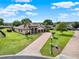 Beautiful home with a three-car garage, paver driveway, well-manicured lawn, and lush landscaping at 16548 Caravaggio Loop, Montverde, FL 34756