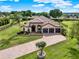 Stunning single-Gathering home showcasing a three-car garage, stone accents, and a paver driveway at 16548 Caravaggio Loop, Montverde, FL 34756