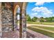 Charming exterior showing brick column, well-kept lawn, and front view of another property at 16548 Caravaggio Loop, Montverde, FL 34756