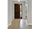 Home entrance featuring tile floors and a dark wood door with glass window at 16548 Caravaggio Loop, Montverde, FL 34756