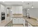 This kitchen features granite countertops, tiled backsplash, stainless appliances, and white cabinets at 16548 Caravaggio Loop, Montverde, FL 34756