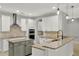 An eat-in kitchen boasts sleek white cabinets, granite countertops, and stainless steel appliances at 16548 Caravaggio Loop, Montverde, FL 34756