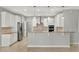 A gourmet kitchen featuring stainless steel appliances, white cabinetry, granite countertops and tile floors at 16548 Caravaggio Loop, Montverde, FL 34756