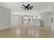 Bright living room with tile floors, a ceiling fan, and an archway that leads to a kitchen at 16548 Caravaggio Loop, Montverde, FL 34756