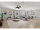 Bright living room featuring stylish furnishings, neutral decor, and a ceiling fan at 16548 Caravaggio Loop, Montverde, FL 34756
