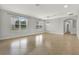 Spacious living area offering tile floors and an archway to a hallway at 16548 Caravaggio Loop, Montverde, FL 34756