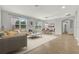Open-concept living room and dining area with neutral tones and ample natural light at 16548 Caravaggio Loop, Montverde, FL 34756