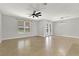 Bright living room with neutral walls, tile floors, ceiling fan, and sliding glass doors to the lanai at 16548 Caravaggio Loop, Montverde, FL 34756