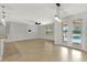 Bright living room with tile flooring, neutral walls, ceiling fan, and sliding glass doors to the pool at 16548 Caravaggio Loop, Montverde, FL 34756