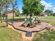 Community playground area featuring slides, swings, picnic tables, and mature shade trees at 16548 Caravaggio Loop, Montverde, FL 34756