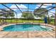 Stunning screened-in pool with a spa, lush landscaping, and ample lounging space at 16548 Caravaggio Loop, Montverde, FL 34756
