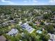 Aerial shot of property with in-ground pool, lush trees and landscaping at 1660 Palmer Ave, Winter Park, FL 32789