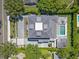 Aerial view of an estate home with a pool, manicured landscaping and a large driveway at 1660 Palmer Ave, Winter Park, FL 32789