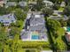 Aerial view of home showcasing pristine pool, landscaping, and rooftop at 1660 Palmer Ave, Winter Park, FL 32789