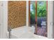 Modern bathroom featuring a soaking tub, wood accent wall, and outdoor patio access with lush greenery at 1660 Palmer Ave, Winter Park, FL 32789