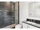 Modern bathroom features glass enclosed shower with stone walls, and a black countertop vanity at 1660 Palmer Ave, Winter Park, FL 32789