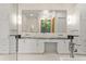 Bright bathroom with double vanity, modern fixtures, and a large mirror reflecting the outdoor scenery at 1660 Palmer Ave, Winter Park, FL 32789