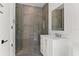 Bathroom showcasing walk-in shower with glass doors, white vanity, and modern mirror at 1660 Palmer Ave, Winter Park, FL 32789