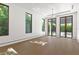 Large bedroom with multiple windows and doors leading to the outdoor living areas, and tile floors at 1660 Palmer Ave, Winter Park, FL 32789
