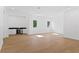 A large bonus room with light hardwood floors, natural light, and a built-in bar area at 1660 Palmer Ave, Winter Park, FL 32789